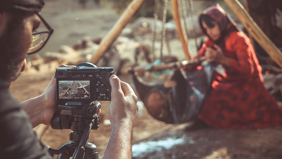 A photographer taking picture of a Bakhtiari nomad girl