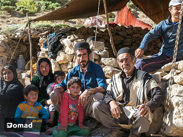A Bakhtiari Nomad Family in Iran sitting in front of their tent
