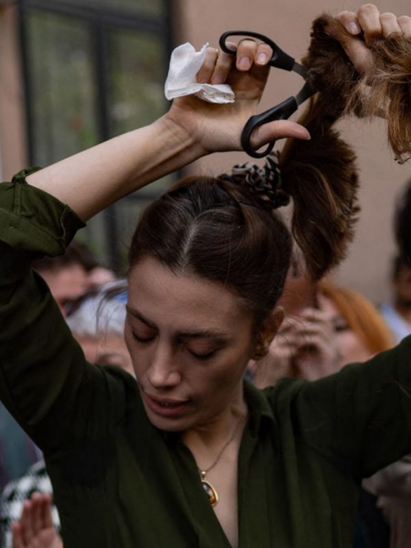 A woman is cutting her hair